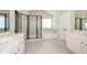 Stylish bathroom featuring marble tile, a glass shower, and a soaking tub at 3405 Linstead Ct, Loganville, GA 30052