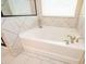 Bright bathtub boasting modern fixtures and decorative tile surround at 3405 Linstead Ct, Loganville, GA 30052