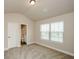 Well-lit bedroom features a large window and access to the ensuite bathroom at 3405 Linstead Ct, Loganville, GA 30052