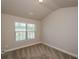 Well-lit bedroom features a large window and neutral carpeting, creating a cozy space at 3405 Linstead Ct, Loganville, GA 30052
