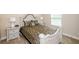 Comfortable bedroom with neutral decor, an upholstered headboard, and side tables with lamps at 3405 Linstead Ct, Loganville, GA 30052