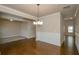 View of dining room features hardwood floors, wainscotting, and open floor plan at 3405 Linstead Ct, Loganville, GA 30052