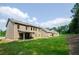 Large backyard with a meticulously kept lawn, wooded border, and covered patio enhances this home's appeal at 3405 Linstead Ct, Loganville, GA 30052