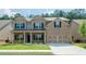 Two-story brick home with a well-manicured lawn and two-car garage at 3405 Linstead Ct, Loganville, GA 30052