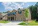 Two-story home featuring a brick facade, neat landscaping, and a spacious two-car garage enhances its curb appeal at 3405 Linstead Ct, Loganville, GA 30052