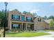 Two-story brick home with a well-manicured lawn, tasteful landscaping, and a two-car garage at 3405 Linstead Ct, Loganville, GA 30052