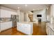 Open kitchen with a center island, hardwood floors, and modern stainless steel appliances at 3405 Linstead Ct, Loganville, GA 30052