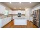Bright kitchen with white cabinets, granite countertops, and stainless steel appliances at 3405 Linstead Ct, Loganville, GA 30052