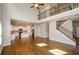 Spacious living room showcases an open floor plan, hardwood floors, and staircase at 3405 Linstead Ct, Loganville, GA 30052