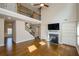 Open living room showcasing hardwood floors, fireplace, and adjacent staircase at 3405 Linstead Ct, Loganville, GA 30052
