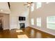 Bright living room featuring hardwood floors, fireplace, large windows, and high ceilings at 3405 Linstead Ct, Loganville, GA 30052