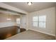 Bright living room with hardwood floors connecting to the dining room at 3405 Linstead Ct, Loganville, GA 30052