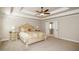 Well-lit primary bedroom with tray ceiling and access to en-suite bathroom at 3405 Linstead Ct, Loganville, GA 30052