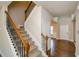 Carpeted staircase with wooden handrail and decorative iron spindles at 3405 Linstead Ct, Loganville, GA 30052