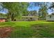 Spacious backyard with a well-maintained lawn, wooden deck, and convenient storage shed at 470 Pretty View Se Ln, Smyrna, GA 30082
