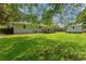 Expansive backyard featuring a wooden deck and a storage shed, perfect for outdoor activities at 470 Pretty View Se Ln, Smyrna, GA 30082