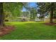 Lush backyard with mature trees, a wooden deck, and storage shed, ideal for relaxation and entertainment at 470 Pretty View Se Ln, Smyrna, GA 30082