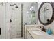 Bathroom featuring glass shower with gray-patterned tile and updated fixtures at 470 Pretty View Se Ln, Smyrna, GA 30082