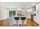 Updated kitchen boasts stainless appliances, island with seating, and modern white cabinetry at 470 Pretty View Se Ln, Smyrna, GA 30082