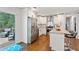 Modern kitchen featuring stainless steel appliances, island, and access to the outdoor deck at 470 Pretty View Se Ln, Smyrna, GA 30082