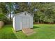 Outdoor shed providing additional storage, accessible by a wooden ramp and featuring double doors at 470 Pretty View Se Ln, Smyrna, GA 30082