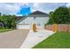 Exterior of home with an attached garage and long driveway at 2000 Settindown Dr, Roswell, GA 30075