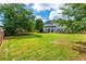 Spacious backyard with a well-maintained lawn, privacy fence, and back of the house at 2000 Settindown Dr, Roswell, GA 30075