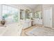 Bright bathroom features double vanity, garden tub under window, and neutral toned walls at 2000 Settindown Dr, Roswell, GA 30075