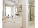 Cozy bathroom featuring vanity with chrome faucet, shower with glass door and white cabinets at 2000 Settindown Dr, Roswell, GA 30075
