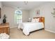 Light-filled bedroom featuring neutral walls, arched window, and comfortable bed at 2000 Settindown Dr, Roswell, GA 30075