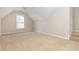 Large bonus room featuring neutral walls, plush carpeting, and a large window for natural light at 2000 Settindown Dr, Roswell, GA 30075