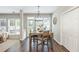 Bright dining area features hardwood floors, large window, and access to the back patio at 2000 Settindown Dr, Roswell, GA 30075