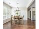 Dining area featuring a modern chandelier, hardwood floors, and natural light at 2000 Settindown Dr, Roswell, GA 30075