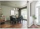 This is the dining room with green walls, hardwood flooring, and a large window at 2000 Settindown Dr, Roswell, GA 30075