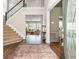 Inviting foyer with hardwood floors, a staircase, and views into the living room at 2000 Settindown Dr, Roswell, GA 30075