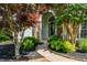 Elegant front entrance with stone archway and manicured landscaping at 2000 Settindown Dr, Roswell, GA 30075