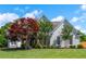 Beautiful exterior featuring a well-manicured lawn, grey siding and mature trees at 2000 Settindown Dr, Roswell, GA 30075