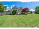 Well-maintained front yard showing the side of the home and fresh cut grass at 2000 Settindown Dr, Roswell, GA 30075