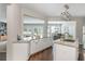 Spacious kitchen with white cabinets, granite countertops and a view of the bright dining area at 2000 Settindown Dr, Roswell, GA 30075