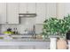 Bright kitchen with white cabinets, tile backsplash, granite countertops and stainless steel appliances at 2000 Settindown Dr, Roswell, GA 30075