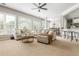 Open-concept living room with a comfortable sectional sofa and abundant natural light at 2000 Settindown Dr, Roswell, GA 30075