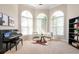Inviting living room featuring a piano, large windows, and neutral decor at 2000 Settindown Dr, Roswell, GA 30075