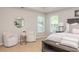 Comfortable main bedroom featuring sitting area with plush chairs, bedside tables, and natural lighting at 2000 Settindown Dr, Roswell, GA 30075