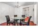 A dining room features a glass table, wood flooring, and chandelier lighting at 2555 Flat Shoals Rd # 2006, Atlanta, GA 30349