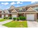 View of the brick townhome exterior featuring a garage and manicured lawn at 2555 Flat Shoals Rd # 2006, Atlanta, GA 30349
