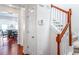 Hallway with hardwood flooring, a staircase, and a view into the dining area at 2555 Flat Shoals Rd # 2006, Atlanta, GA 30349