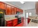 Modern kitchen with granite counters, updated appliances, and cherry wood cabinets at 2555 Flat Shoals Rd # 2006, Atlanta, GA 30349