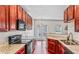 A kitchen showcases granite countertops, stainless steel appliances, and cherry wood cabinetry at 2555 Flat Shoals Rd # 2006, Atlanta, GA 30349