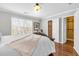 Well-lit bedroom with hardwood floors, a decorative bed frame and closet space at 420 Heritage Park Nw Trce # 22, Kennesaw, GA 30144