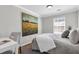Comfortable bedroom with neutral tones, a study desk, window with natural light, and artistic wall decor at 420 Heritage Park Nw Trce # 22, Kennesaw, GA 30144
